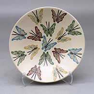 A shallow polychrome bowl decorated with a sgraffito and painted butterfly design
 by Luz Elva Gutierrez of Mata Ortiz and Casas Grandes
