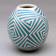 A green on beige jar decorated with a four-panel triangular spiral geometric design
 by Tati Ortiz of Mata Ortiz and Casas Grandes