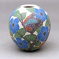 A polychrome jar decorated with a sgraffito and painted butterfly, hummingbird, branch, leaf and flower design
 by Blanca Arras of Mata Ortiz and Casas Grandes