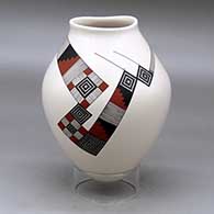 A polychrome jar with an organic opening and decorated with a flowing geometric design
 by Diego Valles of Mata Ortiz and Casas Grandes