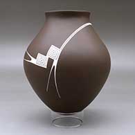 A white on brown jar with a recurved neck and decorated with a geometric design with a hummingbird hovering above the shoulder, click or tap to see a larger version