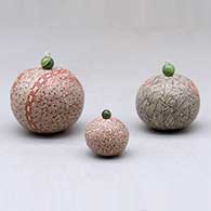 A set of three miniature lidded jars decorated with a serpent, hummingbird, fineline and geometric designs, click or tap to see a larger version