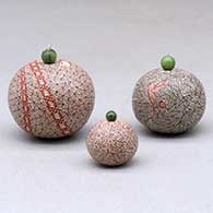 A set of three miniature lidded jars decorated with a serpent, hummingbird, fineline and geometric designs, click or tap to see a larger version