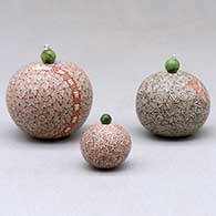 A set of three miniature lidded jars decorated with a serpent, hummingbird, fineline and geometric designs, click or tap to see a larger version