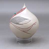 A polychrome tear drop jar decorated with a flower, leaf and geometric design plus an inlaid stone, click or tap to see a larger version