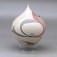 A polychrome tear drop jar decorated with a flower, leaf and geometric design plus an inlaid stone, click or tap to see a larger version