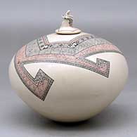 A polychrome jar decorated with a fineline and geometric design and a seated matachine on the lid, click or tap to see a larger version
