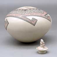 A polychrome jar decorated with a fineline and geometric design and a seated matachine on the lid, click or tap to see a larger version