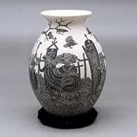A black on white jar with a rolled lip and decorated with a sgraffito Day of the Dead at the Cemetery design
 by Hector Javier Martinez of Mata Ortiz and Casas Grandes
