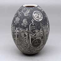 A black on white jar decorated with a sgraffito Night of the Dead under the full moon design
 by Hector Javier Martinez of Mata Ortiz and Casas Grandes