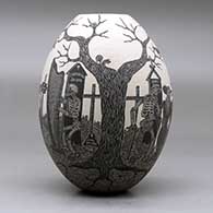 A black on white jar decorated with a sgraffito Day of the Dead at the cemetery design, click or tap to see a larger version