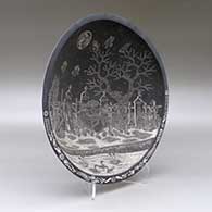 A black on white shallow bowl decorated inside with a sgraffito Day of the Dead at the the Cemetery and geometric design, click or tap to see a larger version