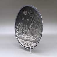 A black on white shallow bowl decorated inside with a sgraffito Day of the Dead at the the Cemetery and geometric design, click or tap to see a larger version