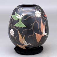 A polychrome jar decorated with a sgraffito and painted hummingbird, flower and vine design
 by Elicena Cota of Mata Ortiz and Casas Grandes