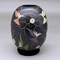 A polychrome jar decorated with a sgraffito and painted hummingbird, flower and vine design
 by Elicena Cota of Mata Ortiz and Casas Grandes