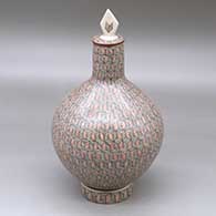 A polychrome medium necked lidded jar with a custom matching stand, all decorated with a fineline geometric design
 by Oralia Lopez of Mata Ortiz and Casas Grandes