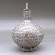 A square necked jar with a matching custom stand, decorated with a fineline spiral geometric design, click or tap to see a larger version