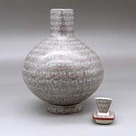 A square necked jar with a matching custom stand, decorated with a fineline spiral geometric design, click or tap to see a larger version