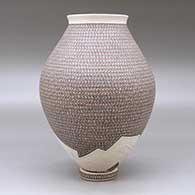 A polychrome jar with a flared lip and decorated with a painted geometric design and a lightly carved geometric design around the base, with a custom matching stand, click or tap to see a larger version