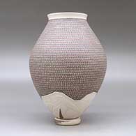 A polychrome jar with a flared lip and decorated with a painted geometric design and a lightly carved geometric design around the base, with a custom matching stand, click or tap to see a larger version