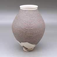 A polychrome jar with a flared lip and decorated with a painted geometric design and a lightly carved geometric design around the base, with a custom matching stand
 by Karla Lopez Cota of Mata Ortiz and Casas Grandes