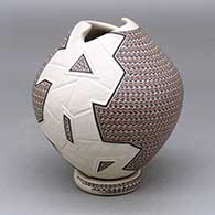 A polychrome jar with a geometric cut opening and decorated with a lightly carved, sgraffito and painted geometric design, with a custom matching stand
 by Karla Lopez Cota of Mata Ortiz and Casas Grandes