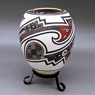 A polychrome jar with a flat top and decorated with a lightly carved and painted two panel serpent, feather and geometric design
 by Tavo Silveira of Mata Ortiz and Casas Grandes