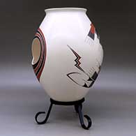 A polychrome jar with two cutouts and decorated with a two-panel geometric design, click or tap to see a larger version