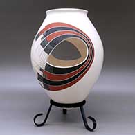 A polychrome jar with two cutouts and decorated with a two-panel geometric design, click or tap to see a larger version