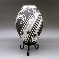 A polychrome jar lightly carved and painted with a three panel serpent, bird element, sickle and geometric design, click or tap to see a larger version