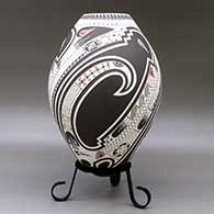 A polychrome jar lightly carved and painted with a three panel serpent, bird element, sickle and geometric design, click or tap to see a larger version