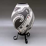 A polychrome jar lightly carved and painted with a three panel serpent, bird element, sickle and geometric design
 by Lazaro Ozuna of Mata Ortiz and Casas Grandes