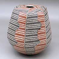 A polychrome hexagonal round bottomed jar decorated with a geometric design
 by Luz Elva Gutierrez of Mata Ortiz and Casas Grandes