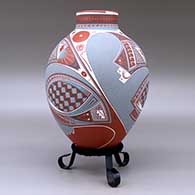 A polychrome jar with a short neck and decorated with a three panel geometric design, click or tap to see a larger version