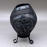 A black jar carved with a lizard, dragonfly, quail, hummingbird, serpent and geometric design
 by Martin Olivas of Mata Ortiz and Casas Grandes