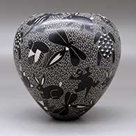 A black on white jar decorated with a sgraffito wildlife and mesh design, click or tap to see a larger version