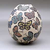 A polychrome jar decorated with a sgraffito and painted butterfly design, click or tap to see a larger version