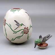 A polychrome jar decorated with a sgraffito and painted hummingbird, flower and vine design, plus a hummingbird lid, click or tap to see a larger version