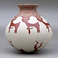 A red on white jar with a rolled lip and decorated with a sgraffito deer and geometric design, click or tap to see a larger version