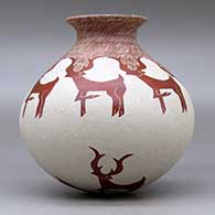 A red on white jar with a rolled lip and decorated with a sgraffito deer and geometric design, click or tap to see a larger version
