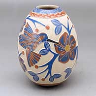 A polychrome jar decorated with a sgraffito and painted hummingbird, flower, branch, leaf, berry and geometric design
 by Melissa Tena of Mata Ortiz and Casas Grandes