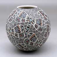 A polychrome jar decorated with a sgraffito and painted dragonfly and spiral mesh geometric design
 by Ailadi Mijarez of Mata Ortiz and Casas Grandes