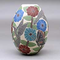 A polychrome jar decorated with a sgraffito and painted hummingbird, butterfly, flower, leaf and branch design, click or tap to see a larger version
