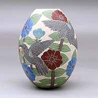 A polychrome jar decorated with a sgraffito and painted hummingbird, butterfly, flower, leaf and branch design, click or tap to see a larger version