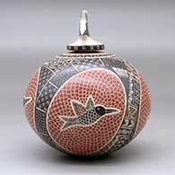 A polychrome jar decorated with a sgraffito and painted hummingbird, mesh and geometric design, with a matching hummingbird lid, click or tap to see a larger version