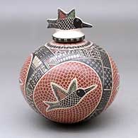 A polychrome jar decorated with a sgraffito and painted hummingbird, mesh and geometric design, with a matching hummingbird lid
 by Angela Corona of Mata Ortiz and Casas Grandes