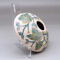A polychrome seed pot decorated with a lightly carved, sgraffito and painted hummingbird, vine, flower and berry design, click or tap to see a larger version