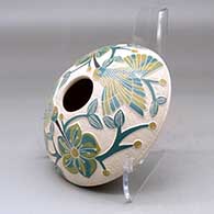 A polychrome seed pot decorated with a lightly carved, sgraffito and painted hummingbird, vine, flower and berry design, click or tap to see a larger version