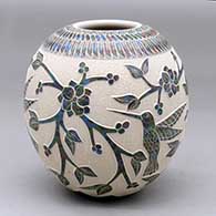 A polychrome jar decorated with a slipped and sgraffito hummingbird, branch, leaf, berry and geometric design
 by Lupita Quezada of Mata Ortiz and Casas Grandes