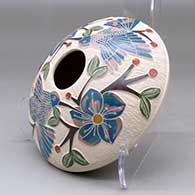 A polychrome seed pot decorated with a lightly carved, sgraffito and painted hummingbird, vine, flower and berry design, click or tap to see a larger version